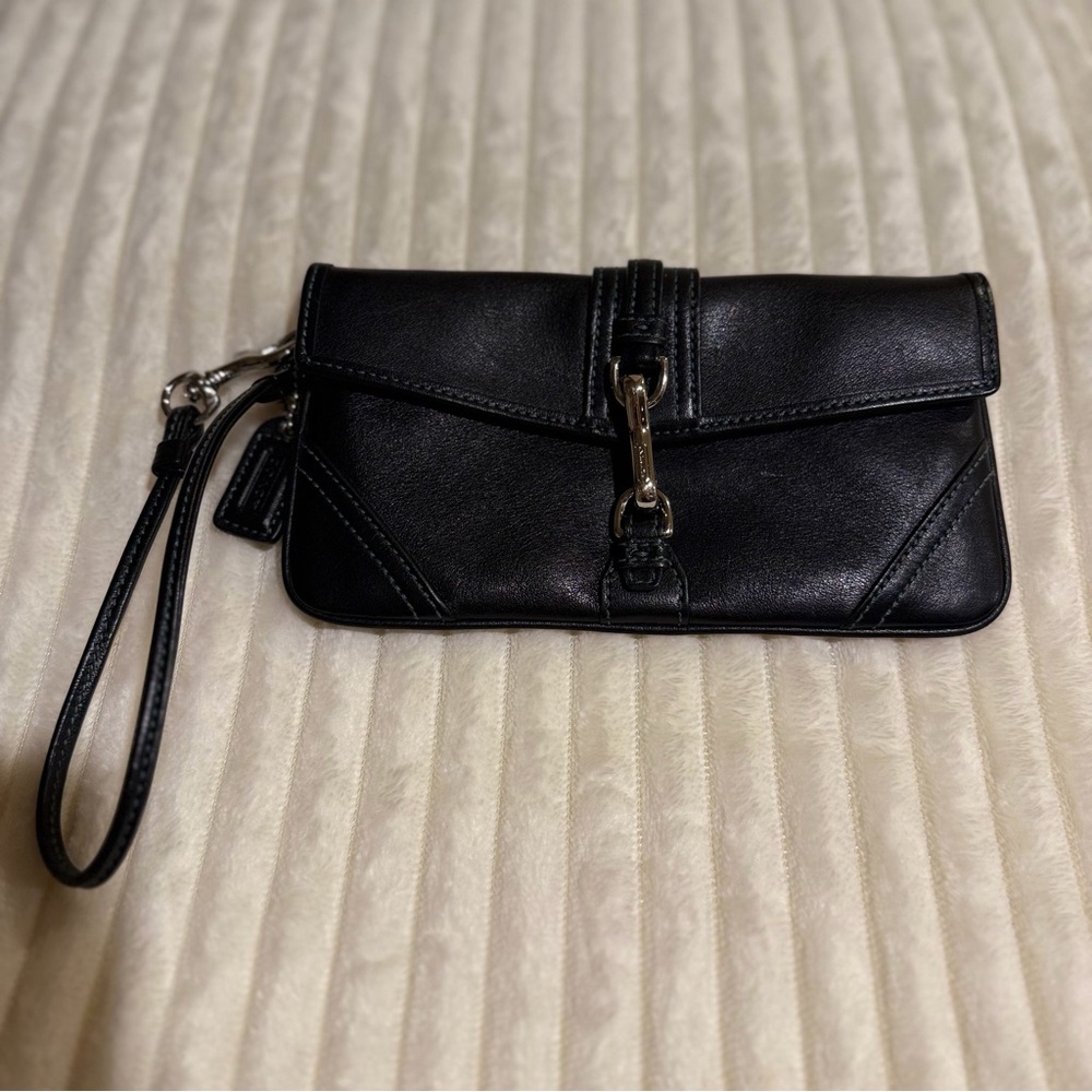 Rare Vintage Coach leather wristlet with light blue contrast stitching.